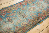 Low pile and cochineal red, gold, antique ivory floral sprays on sky blue hand-knotted Kerman runner.