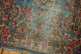 Vintage Kerman rug's low pile with clear foundation, sky blue field, and cochineal floral sprays.