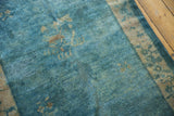 Faded floral motifs on distressed Peking rug with low pile sky blue and ivory.