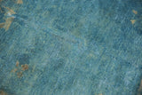 Distressed Peking rug low pile texture, sky blue, antique ivory, and exposed knot heads.