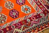Vintage Caucasian Kilim showing tangerine field, geometric guls, and multi-patterned red border.