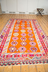 End of a vintage Caucasian Kilim rug with geometric guls and colorful fringe.
