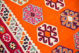 Vintage Caucasian Kilim detail: tangerine orange field, funky geometric pinwheel guls.
