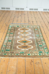 Distressed low pile and fringed bottom edge of a Jaldar rug with geometric patterns.
