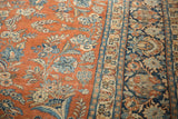 Vintage Distressed Mahal carpet's pale rust floral field and intricate dark teal border.