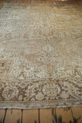 Distressed texture of the vintage Heriz rug border with geometric motifs in ivory and brown.