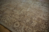 Distressed Heriz rug texture, showcasing low pile, exposed knot heads, and geometric brown vinery.