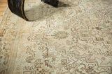 Distressed low pile texture with geometric serrated leaves and floral palmettes in ivory.