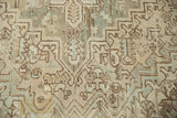Distressed Heriz carpet: low pile texture, geometric palmettes in ivory, brown, pale blue-green.