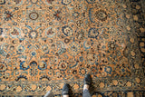 Distressed vintage Persian Meshed carpet with allover floral palmettes, lotus flowers, and softened blues.