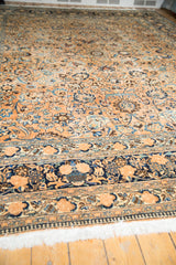 Distressed vintage Meshed rug detail: navy border with palmettes, floral motifs, and fringe.