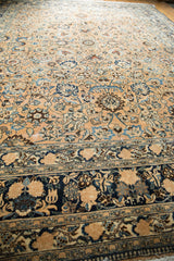 Textured distressed Meshed carpet in soft beige with sky blue palmette and floral motifs.
