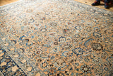 Softened texture and even wear on a vintage Meshed carpet, showcasing beige and sky blue floral motifs.