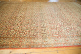 Traditional Persian Qom carpet border with rust, ivory, and blue germinating flower motifs.