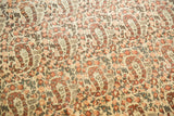 Repeating paisley boteh motif, germinating flowers, in ivory, rust, and moss green.