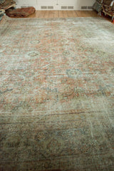 Distressed Mahal carpet's worn pile texture with faded rose, ivory, and charcoal tones.