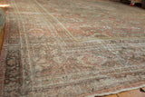 Faded dusty blush pile and worn palmette motifs on the vintage distressed Mahal rug.
