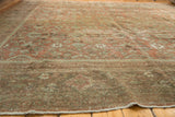 Close-up of distressed Vintage Mahal rug pile, showing faded dusty blush and sea foam patterns.