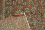 Corner view of vintage distressed Mahal rug, showing faded palmette pile and tight hand-knotted foundation.