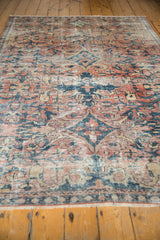 Distressed Mahal carpet, muted red, teal, sand scrolling floral patterns, and low pile texture.