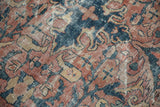 Distressed Mahal carpet showing exposed foundation, low pile, brick red, and teal.