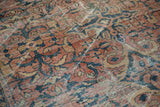 Mahal rug showing distressed pile, exposed foundation, and faded brick red floral motifs.