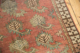 Time-softened terracotta field of antique Afghan runner, unique stylized boteh, and geometric border.