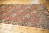Antique Afghan runner's corner detail: chocolate brown geometric border with chestnut terracotta boteh.