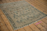 Corner of vintage Afshar rug, showing serrated leaf border, planter motif, and end pile reduction.
