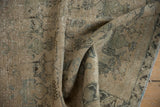 Folded vintage Afshar rug with geometric motifs, antique ivory, beige, and slate blue showing foundation.