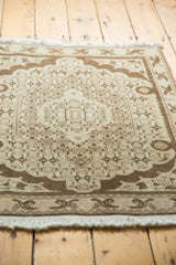 Vintage Bijar rug corner featuring chocolate brown arabesque border and ivory fringe.