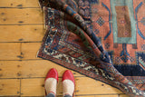 Hand-knotted antique Afshar rug border with intricate geometric patterns in navy, terracotta, and ivory.