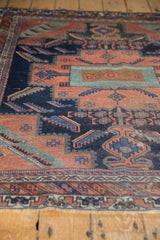 Textured antique Afshar rug field showcasing terracotta and navy stepped geometric motifs.