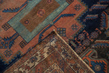 Visible hand-knotted foundation and geometric terracotta and navy design of the Afshar rug.