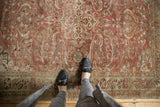 Decorative distressed Lilihan rug, copper quatrefoil medallion and bronze floral patterns.
