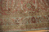 Distressed Lilihan rug's low pile, revealing faded copper, bronze, and dusty blue tones.
