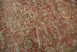 Faded copper and pale bronze scrolling floral pattern on distressed Lilihan rug.