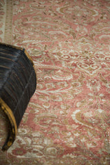 Distressed Lilihan rug's low pile texture with faded copper, ivory, and pale bronze florals.