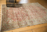 Corner of distressed Lilihan rug, showing copper and antique ivory hues with visible knot heads.