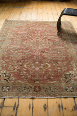 Corner of distressed Lilihan rug, copper, bronze, ivory floral motifs, low pile texture.