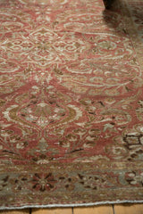Distressed Lilihan rug's low pile, copper and bronze scrolling florals with visible foundation.