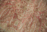 Distressed Lilihan rug detail featuring copper, pale bronze, and ivory scrolling patterns.