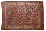 Antique Turkmen carpet, allover staggered guls on a plum field, with aubergine, teal, and madder red.