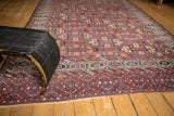 Antique Turkmen carpet displaying staggered guls on an abrashed aubergine field with varied, rich colors.