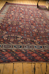 Ivory and teal geometric key pattern border of an antique Turkmen carpet with fringe.