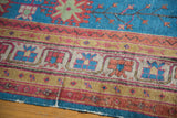 Vintage Khotan rug's corner shows sapphire blue, cherry red, gold, and ivory textured patterns.