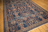 Antique Persian Mahal carpet: navy field, blossomed florals, terra cotta, and low pile.
