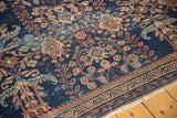 Antique Mahal carpet's navy field displays blossomed terra cotta and green florals, with low pile.