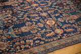 Antique Mahal rug detail: navy floral field, terra cotta, green hues, visible low pile and age patina.