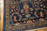 Antique Mahal carpet corner: navy floral field, low pile, detailed border, and fringe.